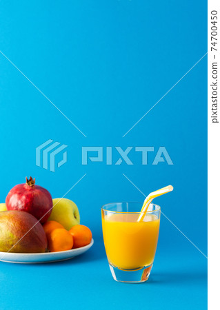 Orange or mango juice in glass and ripe fruits Orange or mango juice in glass and ripe fruits 74700450