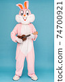 Guitar player or guitarist is playing music by ukulele. Easter bunny or rabbit or hare celebrates Happy easter, dancing, plays music by Hawaiian guitar 74700921