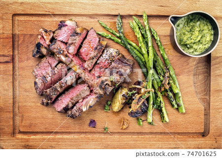 Barbecue dry aged wagyu porterhouse steak sliced with green asparagus, Barbecue dry aged wagyu porterhouse steak sliced with green asparagus, 74701625