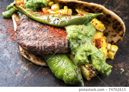 wagyu hash burger with flatbread, pineapple and chimichurri sauce offered wagyu hash burger with flatbread, pineapple and chimichurri sauce offered 74702615