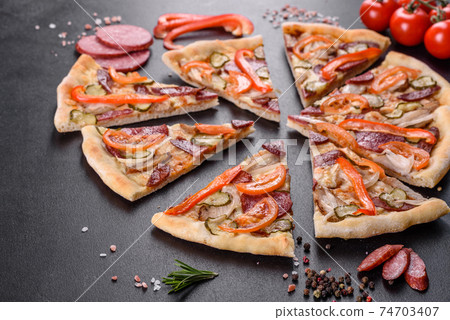 Fresh delicious pizza made in a hearth oven with sausage, pepper and tomatoes Fresh delicious pizza made in a hearth oven with sausage, pepper and tomatoes 74703407