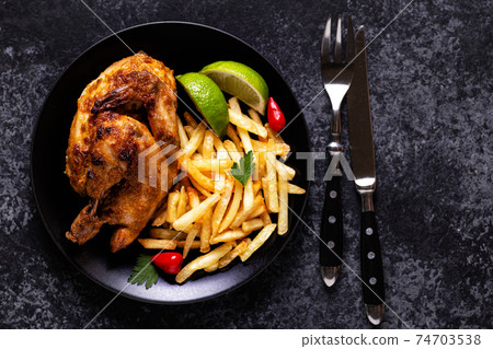 Half roasted chicken Piri Piri with french fries 74703538