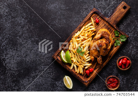 Half roasted chicken Piri Piri with french fries 74703544