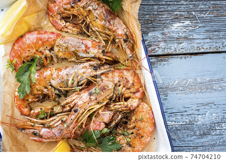 Traditional fried black tiger prawn with lemon Traditional fried black tiger prawn with lemon 74704210