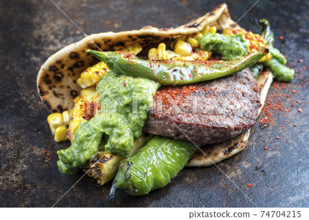 wagyu hash burger with flatbread, pineapple and chimichurri 74704215