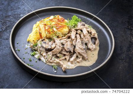 Traditional Swiss zuercher geschnetzeltes with roesti 74704222