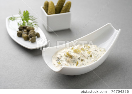 Modern style German remoulade with gherkin and cappers 74704226