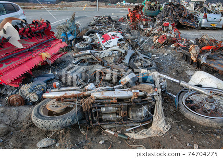 Photograph of a motorcycle damaged by the Great East Japan Earthquake taken on December 10, 2011 Kesencho, Rikuzentakata City, Iwate Prefecture 74704275