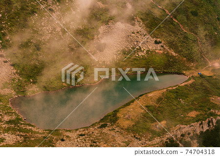 View from Mount Gutyn Tomnatyk to Lake Brebeneskul, a lake in the valley of the Carpathian Mountains, the highest lake in Ukraine. 74704318