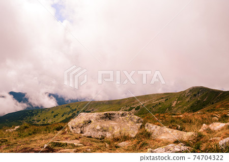 At the top of the mountain Gutyn Tomnatyk, the view from the mountain on the Montenegrin overcast ridge, breathtaking landscapes, enchant with their grandeur. 74704322