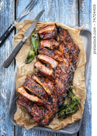 Barbecue spare ribs baby back style with hot honey chili marinade 74704409