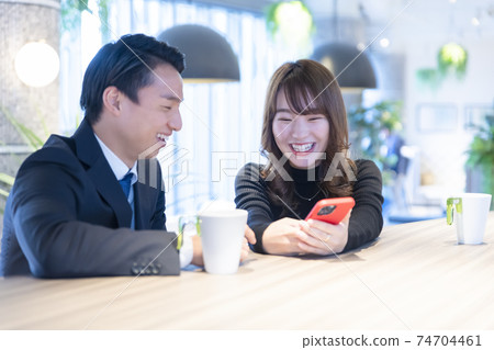 A couple talking in a cafe 74704461