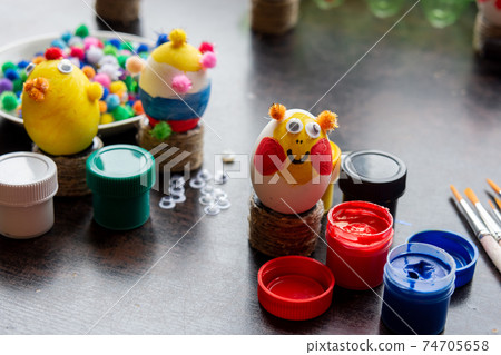 Easter egg crafts, paints and decorative elements are on the table Easter egg crafts, paints and decorative elements are on the table 74705658