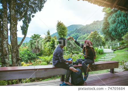 Asian couple travel photograph nature education. nature relax and study read a book. at public park Asian couple travel photograph nature education. nature relax and study read a book. at public park 74705684