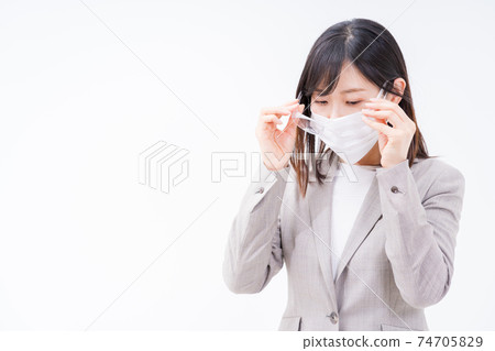 Business woman trying to wear goggles to prevent hay fever 74705829