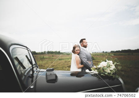 Caucasian happy romantic young couple celebrating their marriage. Outdoor Caucasian happy romantic young couple celebrating their marriage. Outdoor 74706502