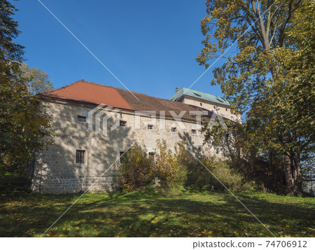 Medieval early Gothic Castle Houska in north Bohemia in autumn time, Czech republic. Houska Castle is one of the best preserved castles of the period. Sunny day blue sky. 74706912