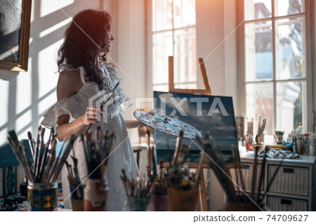 woman artist paint with brushes and oil dye 74709627
