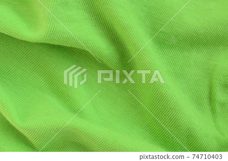The texture of the fabric is bright green. Material for making shirts and blouses The texture of the fabric is bright green. Material for making shirts and blouses 74710403