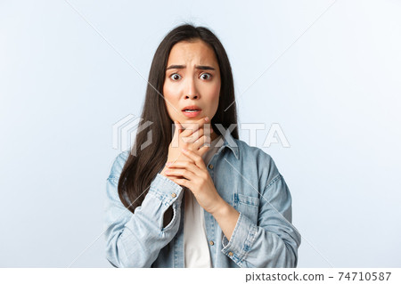 Lifestyle, people emotions and beauty concept. Shocked, scared and concerned asian girl feeling sorry about friend got accident, gasping frowning terrified, hear terrible news 74710587