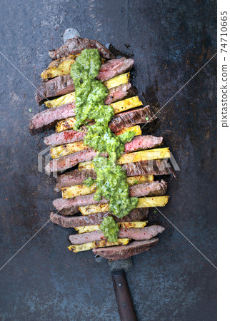 dry aged wagyu flank steak with pineapples and chimichurri sauce  74710665