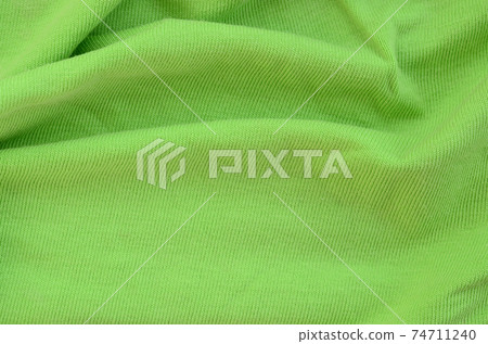 The texture of the fabric is bright green. Material for making shirts and blouses The texture of the fabric is bright green. Material for making shirts and blouses 74711240