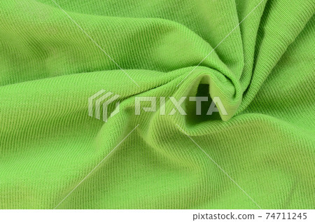The texture of the fabric is bright green. Material for making shirts and blouses 74711245
