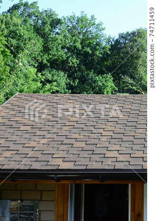 Modern roofing and decoration of chimneys. Flexible bitumen or slate shingles 74711459