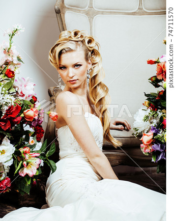 beauty emotional blond bride in luxury interior dreaming, crazy complicate hairstyle, many flowers beauty emotional blond bride in luxury interior dreaming, crazy complicate hairstyle, many flowers 74711570