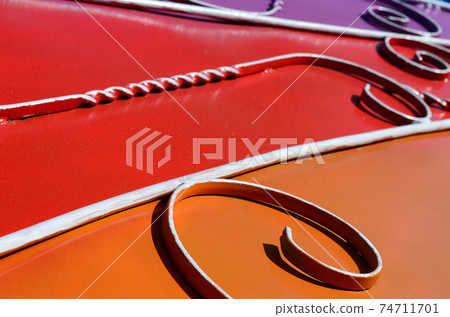 Metal texture of a piece of colored wall with a forged pattern Metal texture of a piece of colored wall with a forged pattern 74711701