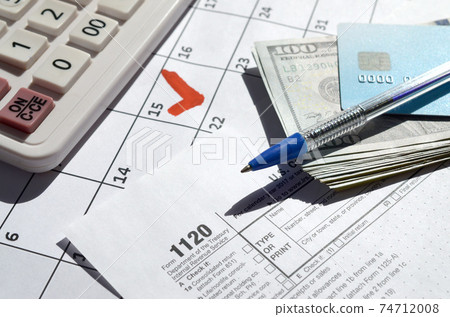 1120 Corporation Income Tax Return blank with dollar bills, calculator and pen on calendar page with marked 15th April 1120 Corporation Income Tax Return blank with dollar bills, calculator and pen on calendar page with marked 15th April 74712008