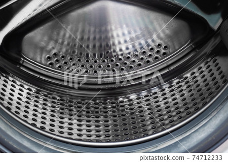 The washing machine drum inside close up 74712233