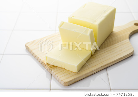 Cut butter on a cutting board 74712583