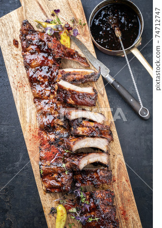 Tradtional barbecue spare ribs baby back style with hot honey chili marinade Tradtional barbecue spare ribs baby back style with hot honey chili marinade 74712747