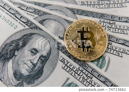 Bitcoin on USD banknotes of one hundred dollar. Virtual money investment. Cryptocurrency business concept. Bitcoin on USD banknotes of one hundred dollar. Virtual money investment. Cryptocurrency business concept. 74713662