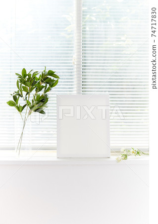 Blank picture frame by the window Blank picture frame by the window 74717830