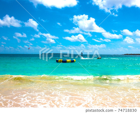 The new flyboard at Caribbean tropical beach The new flyboard at Caribbean tropical beach 74718830