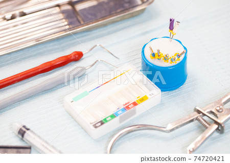 dental equipment and instruments on a sterile table. root canal treatment instruments 74720421