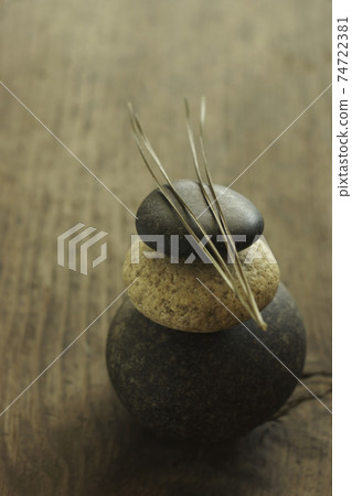 Pine needles on stacked cobblestones 74722381