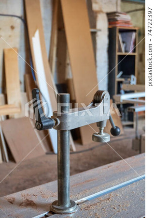 Joinery. Table saw clamp in workshop, close-up Joinery. Table saw clamp in workshop, close-up 74722397