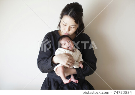 New mom holding a newborn baby 74723884