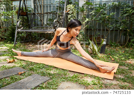 Fit woman stretching outdoors Fit woman stretching outdoors 74725133