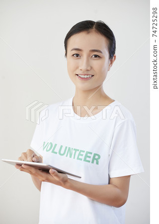 Smiling volunteer organization member Smiling volunteer organization member 74725298