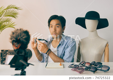 Asian Vlogger or Blogger Recording Video of Fashion Glasses Review in Vintage Tone Asian Vlogger or Blogger Recording Video of Fashion Glasses Review in Vintage Tone 74725322