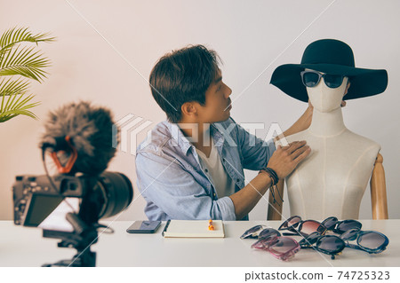Asian Vlogger or Blogger Put Fashion Glasses to Mannequins and Recording Video in Vintage Tone Asian Vlogger or Blogger Put Fashion Glasses to Mannequins and Recording Video in Vintage Tone 74725323
