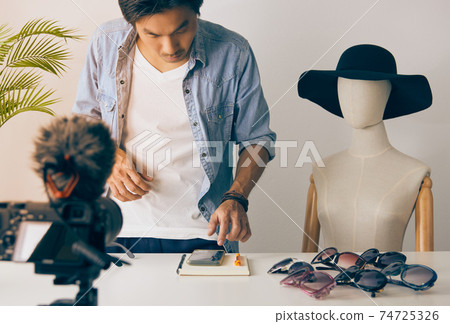Standing Asian Vlogger or Blogger Online Chat with Customer While Recording Video in Vintage Tone Standing Asian Vlogger or Blogger Online Chat with Customer While Recording Video in Vintage Tone 74725326