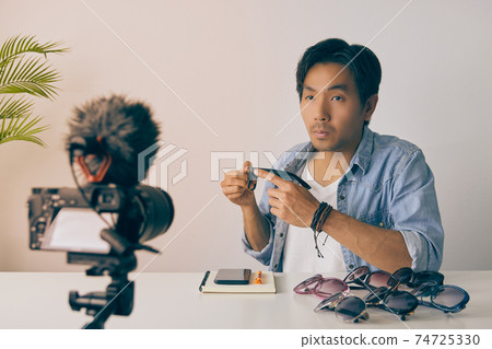 Front Asian Vlogger or Blogger Review Fashion Glasses by Video Recording in Vintage Tone 74725330