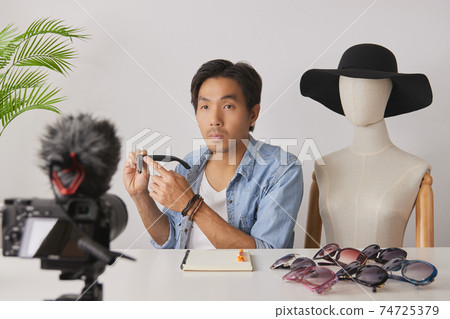 Asian Vlogger or Blogger Recording Video of Fashion Glasses Review 74725379