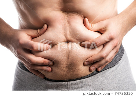 Male hands wrinkle a bulging plump belly Male hands wrinkle a bulging plump belly 74726330
