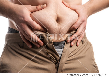 Male hands squeeze a bulging plump belly 74726334